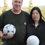 David Baxter and his Japanese wife Yumi pose with a soccer ball which they found at a remote site in the Gulf of Alaska