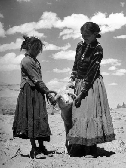Native American Indian children playing with ram.