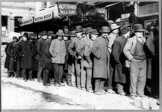Bowery men waiting for bread in breadline.