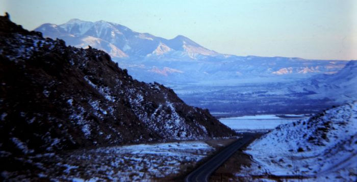 Then-US 163 headed south... 1975 Moab in the middle ground, the La Sals in the distance. photo by Jim Stiles