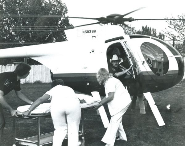 Lynn Izatt loading a stretcher onto a helicopter