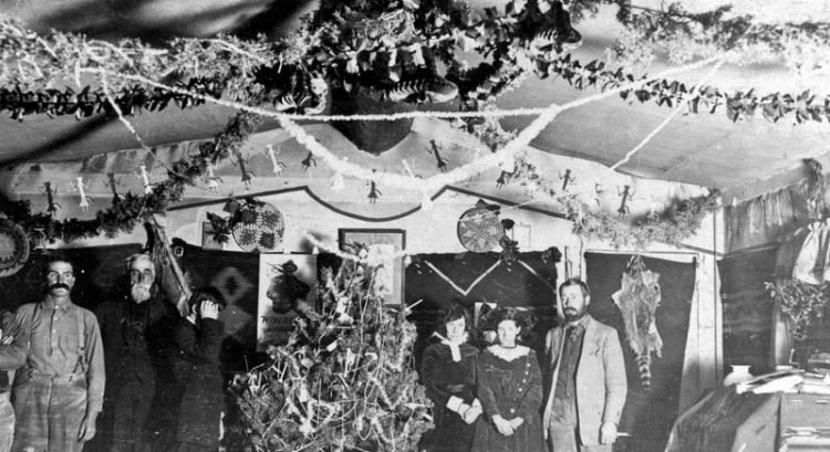 An early-day Christmas celebration (ca. 1911) in the Wetherills’ home. Louisa to the right of the tree, daughter Georgia to the right of her, and son Ben (hiding his face) to the left of the tree. The man to the left of Ben is Justus Tompkins, John Wetherill’s uncle. The other men are unidentified guests—maybe prospectors.