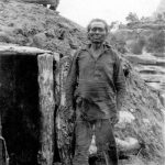 The spiritual home of the traditional Navajos was their enduring natural surroundings rather than their temporary hogan shelters. Nede Cloey (Nii'ditt'oii) at his hogan in Tsegi Canyon