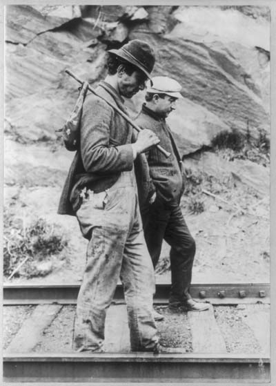 Two hobos walking along railroad tracks, after being put off a train. Library of Congress.