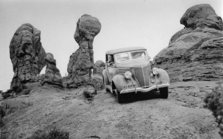 Harry Goulding, founder of Goulding's Trading Post in Monument Valley, driving at Arches in the early 40s. Photo by Harry Reed.