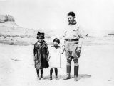 The artist and cartoonist, James Swinnerton, on the right with some real canyon kiddies—Betty and Fanny Wetherill