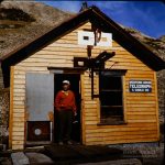"Harry at Alpine Tunnel." Not certain whether Harry was a friend, or just another traveler Herb encountered at this remote ghost of a gold rush settlement. Harry is standing in the old telegraph office, constructed in 1883 for the then-bustling spot at the west portal to the tunnel. 1977. Photo by Herb Ringer