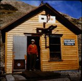 "Harry at Alpine Tunnel." Not certain whether Harry was a friend, or just another traveler Herb encountered at this remote ghost of a gold rush settlement. Harry is standing in the old telegraph office, constructed in 1883 for the then-bustling spot at the west portal to the tunnel. 1977. Photo by Herb Ringer