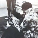 A photo of Mary Floyd, from the college yearbook. She's pictured helping one of the kids in the daycare.
