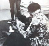 A photo of Mary Floyd, from the college yearbook. She's pictured helping one of the kids in the daycare.