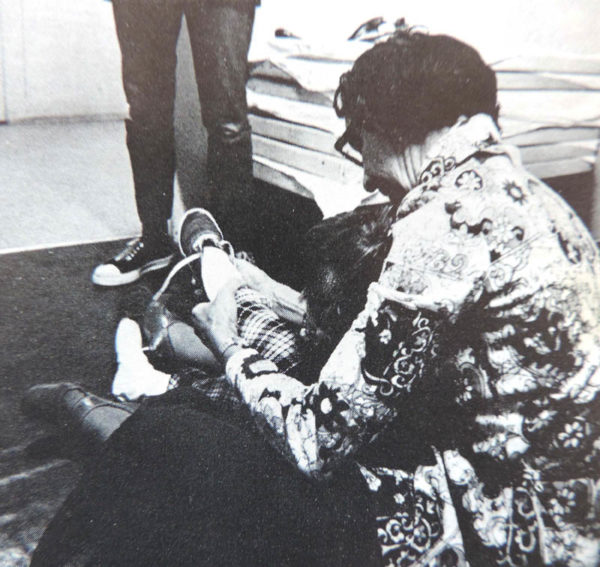 A photo of Mary Floyd, from the college yearbook. She's pictured helping one of the kids in the daycare. 