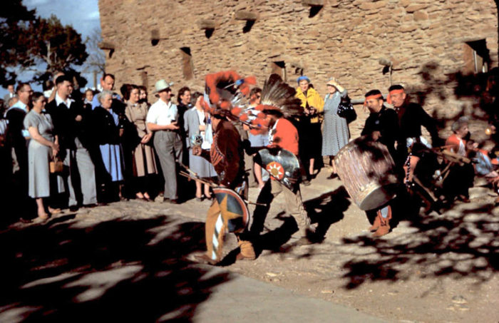 A group of tourists enjoying a Tribal Dance at the South Rim of the Grand Canyon. 1950. Photo by Herb Ringer